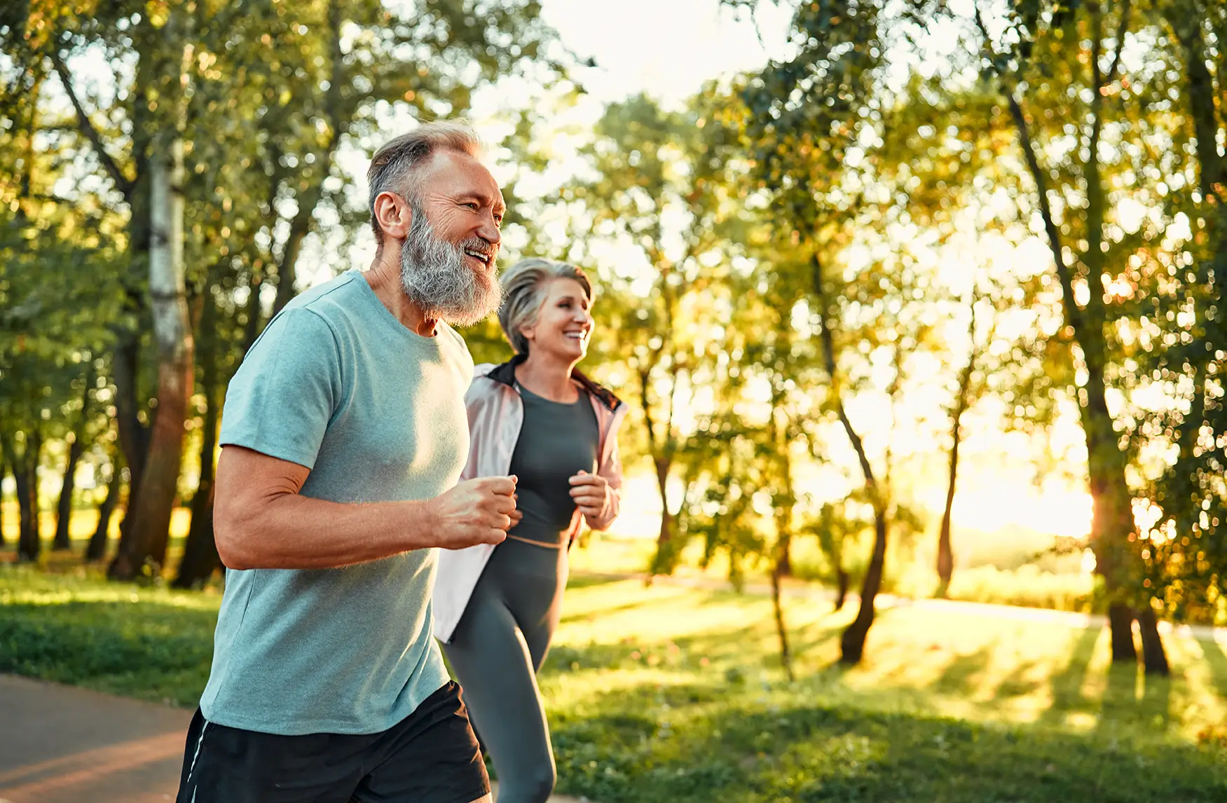 Younger and older man walking together by lake, symbolizing financial planning guidance in Spring, TX.